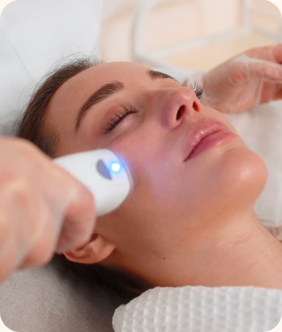Woman receiving an LED facial treatment